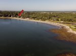 This 2015 aerial view shows the cottage is on a long walkable beach